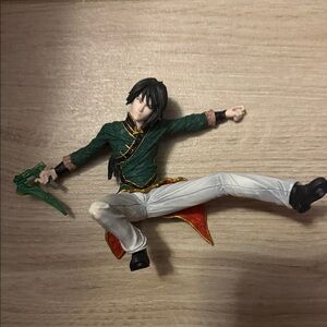 Action Figure with Green Outfit and Black Hair